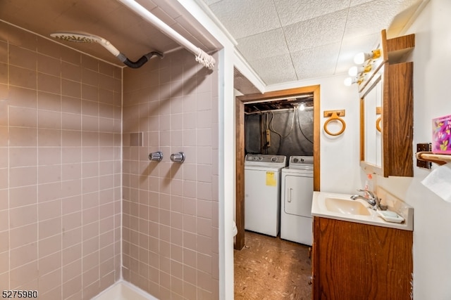 bathroom with independent washer and dryer and vanity