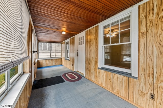 unfurnished sunroom with wooden ceiling and ceiling fan