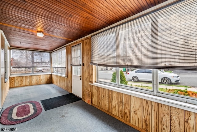 unfurnished sunroom with wood ceiling