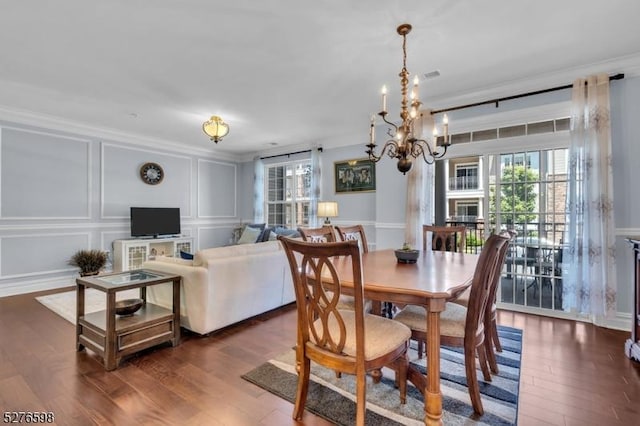 1103 Enclave Cir, Franklin Twp, NJ 08873 - dining room with a decorative wall, dark wood-style floors, a chandelier, and ornamental molding