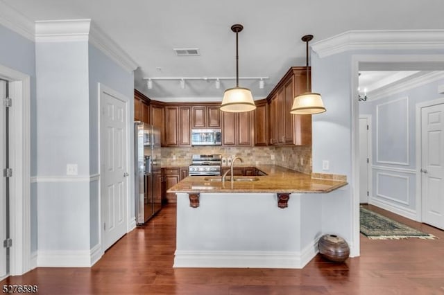 1103 Enclave Cir, Franklin Twp, NJ 08873 - kitchen with stainless steel appliances, a peninsula, dark wood-style flooring, light stone counters, and decorative backsplash
