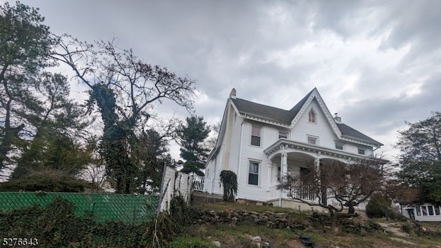 view of side of home with covered porch