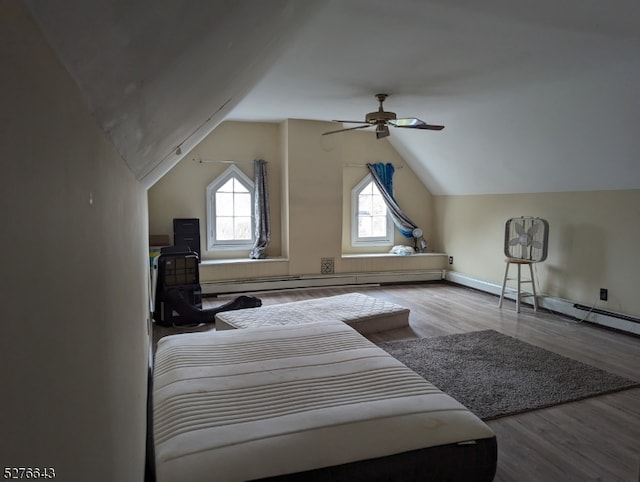 bedroom featuring ceiling fan, hardwood / wood-style floors, vaulted ceiling, and multiple windows