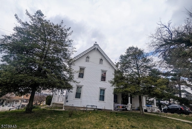 rear view of house with a lawn