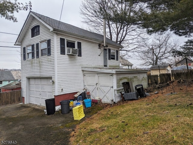 rear view of property featuring a garage