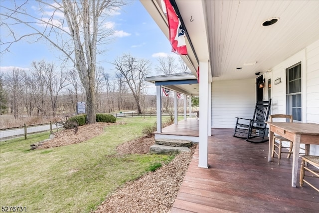 wooden deck featuring a yard