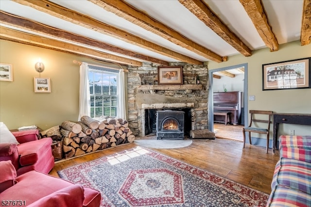 living room with beam ceiling, wood-type flooring, and a fireplace