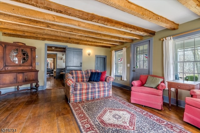 living room with dark hardwood / wood-style flooring and beam ceiling