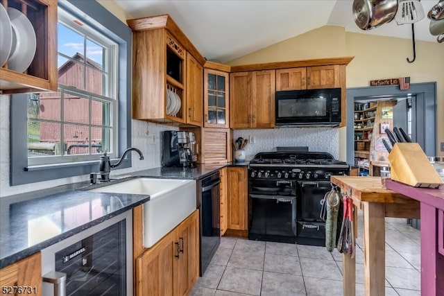 kitchen with light tile floors, backsplash, black appliances, beverage cooler, and lofted ceiling