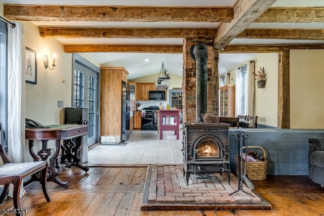 living room featuring french doors, a wood stove, vaulted ceiling with beams, and light tile flooring