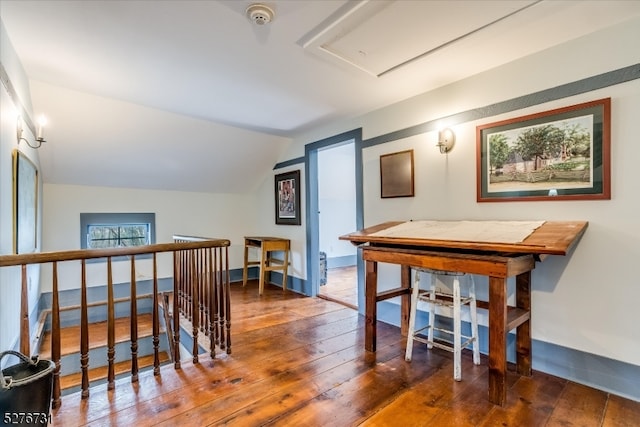 hall with dark hardwood / wood-style floors and lofted ceiling