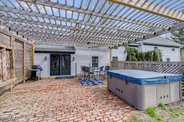 view of patio / terrace with a pergola, a hot tub, and grilling area