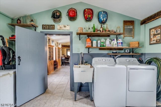 washroom featuring separate washer and dryer and light tile floors