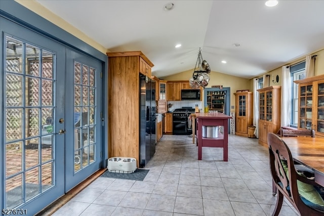 kitchen with light tile floors, plenty of natural light, backsplash, and black appliances