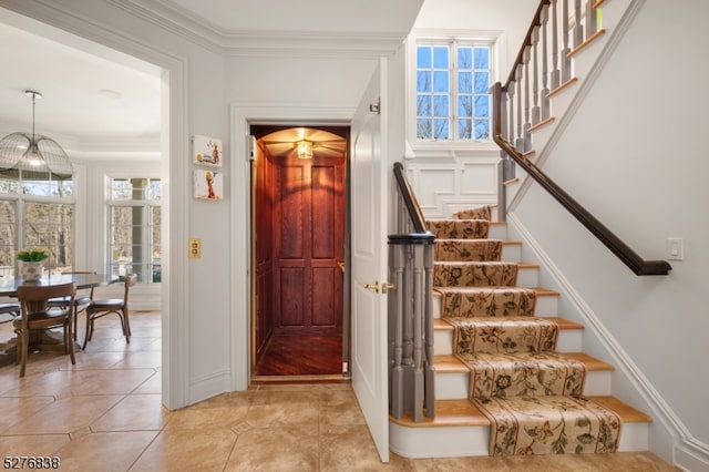 interior space with light tile floors and crown molding