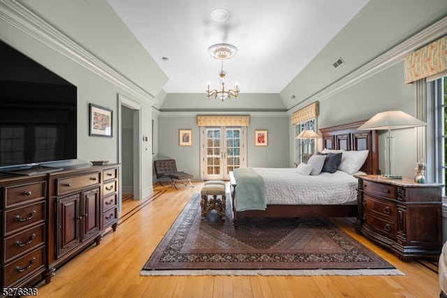 bedroom featuring crown molding, light wood-type flooring, and a chandelier