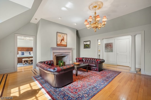 living room featuring a notable chandelier, vaulted ceiling, and wood-type flooring