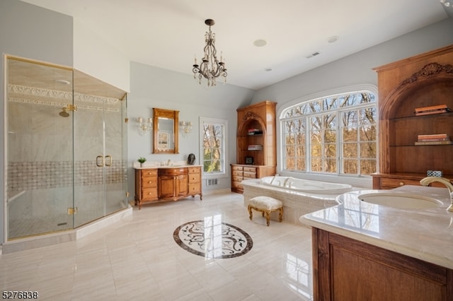 bathroom with a notable chandelier, tile flooring, plus walk in shower, and vanity