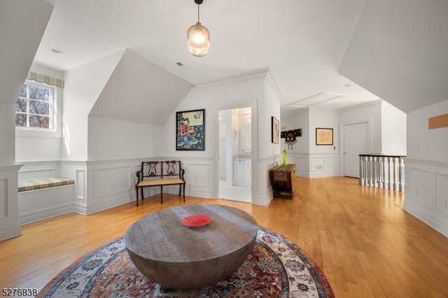 living area featuring light hardwood / wood-style floors and vaulted ceiling