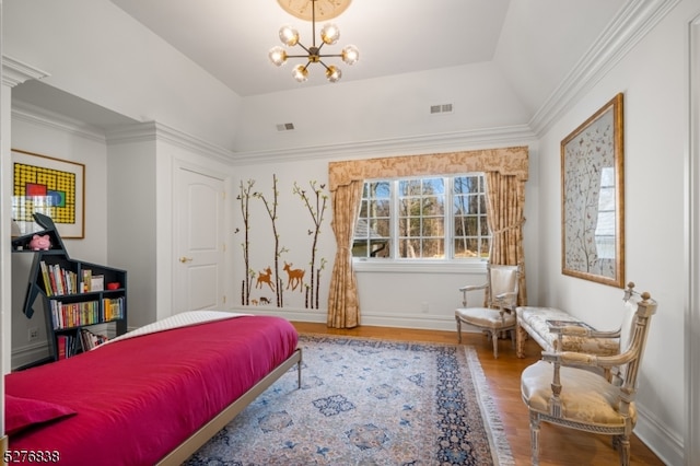 bedroom featuring vaulted ceiling, a chandelier, a raised ceiling, hardwood / wood-style floors, and ornamental molding