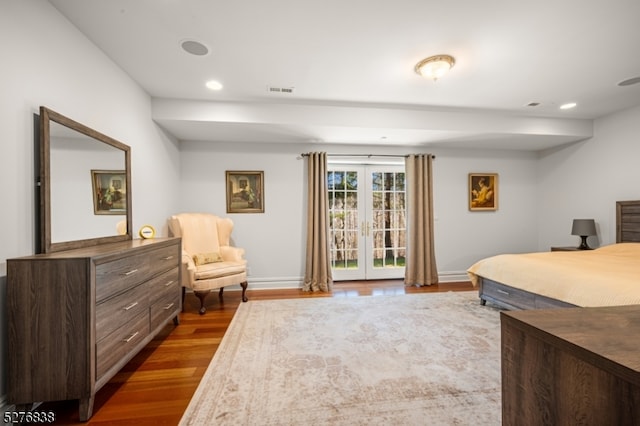 bedroom with wood-type flooring, access to exterior, and french doors