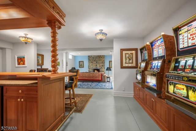 interior space with ornate columns and a stone fireplace