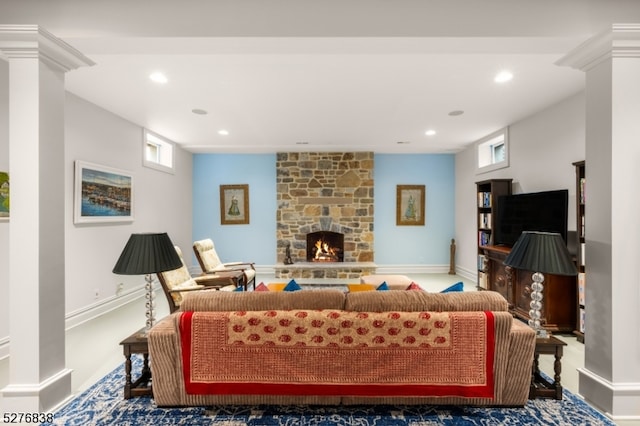 living room with a fireplace and decorative columns