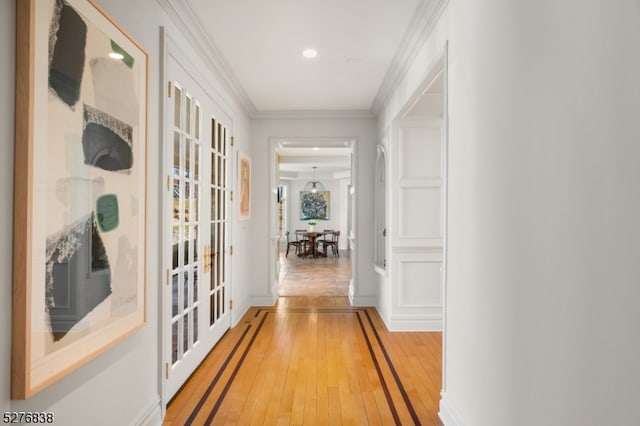 hall featuring tile flooring and ornamental molding