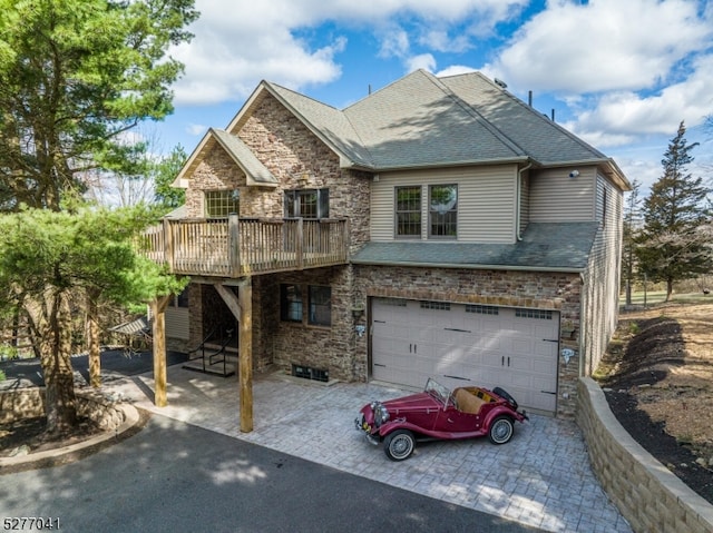 view of front of home with a wooden deck and a garage