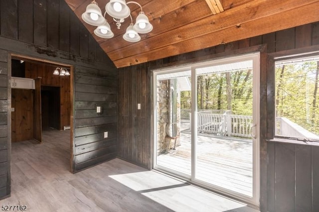 4 Amicalola Dr, Vernon Twp, NJ 07422 - unfurnished room featuring light wood-type flooring, vaulted ceiling, wooden walls, and a notable chandelier