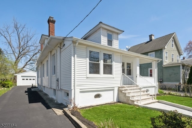 view of front facade featuring a garage and an outdoor structure