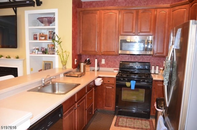 kitchen featuring stainless steel appliances, tasteful backsplash, light countertops, a sink, and a peninsula