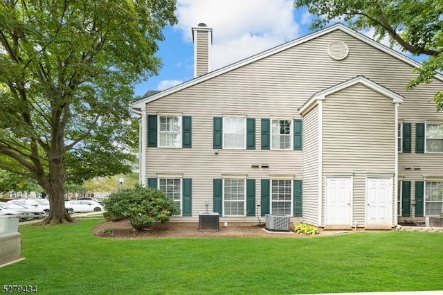 193 Columbus Dr Unit 193, Franklin Twp, NJ 08823 - back of property featuring a chimney, a lawn, and cooling unit