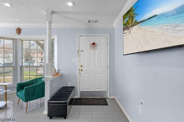 193 Columbus Dr Unit 193, Franklin Twp, NJ 08823 - tiled foyer with ornate columns, crown molding, a textured ceiling, baseboards, and view of local beach