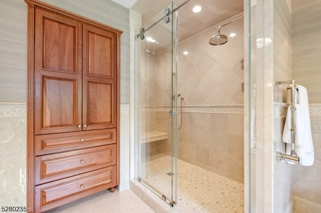 bathroom featuring a shower with door and tile flooring