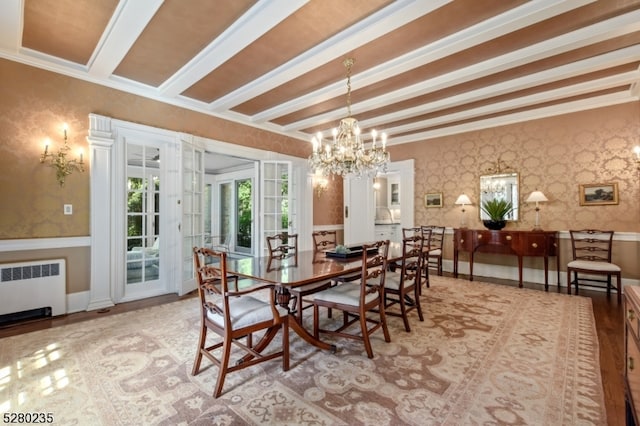 dining room featuring french doors, radiator, light hardwood / wood-style floors, beamed ceiling, and a chandelier