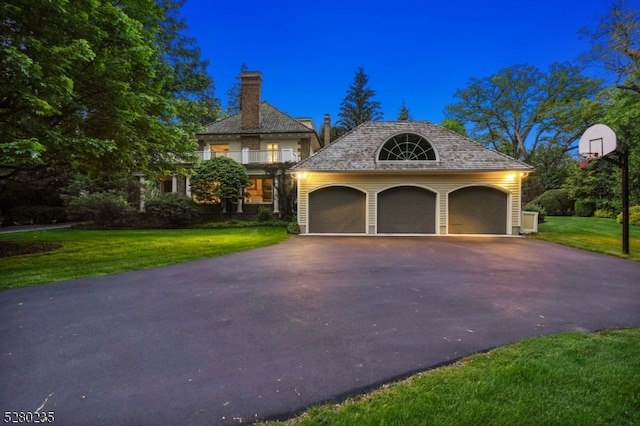 view of front of home featuring a garage and a lawn