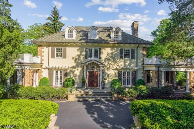 colonial inspired home featuring a balcony