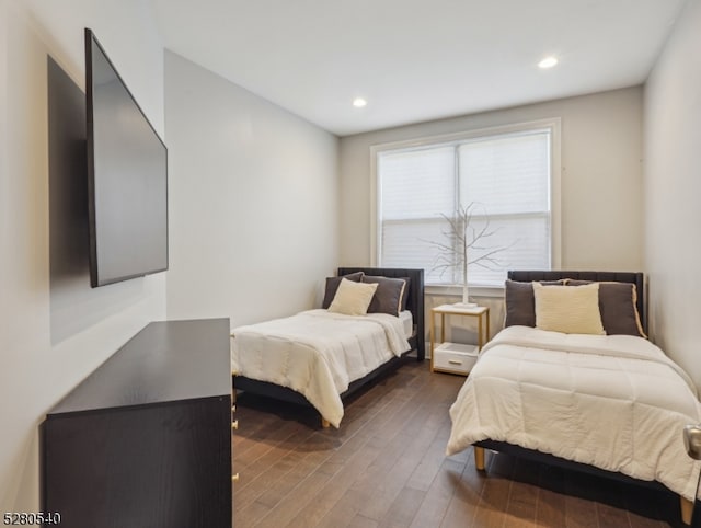 bedroom with dark wood-type flooring