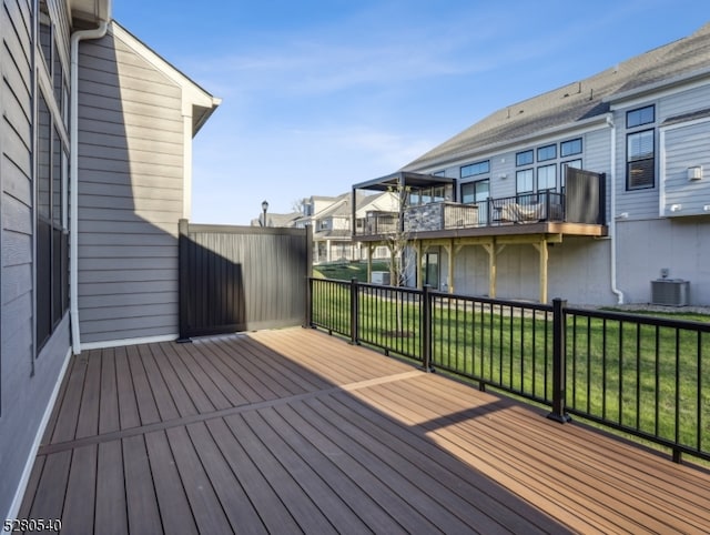 wooden deck with a yard and central AC