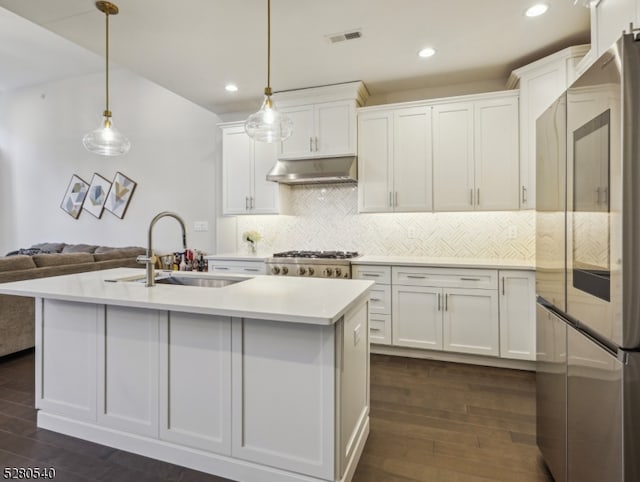 kitchen featuring dark hardwood / wood-style flooring, stainless steel refrigerator, and white cabinetry