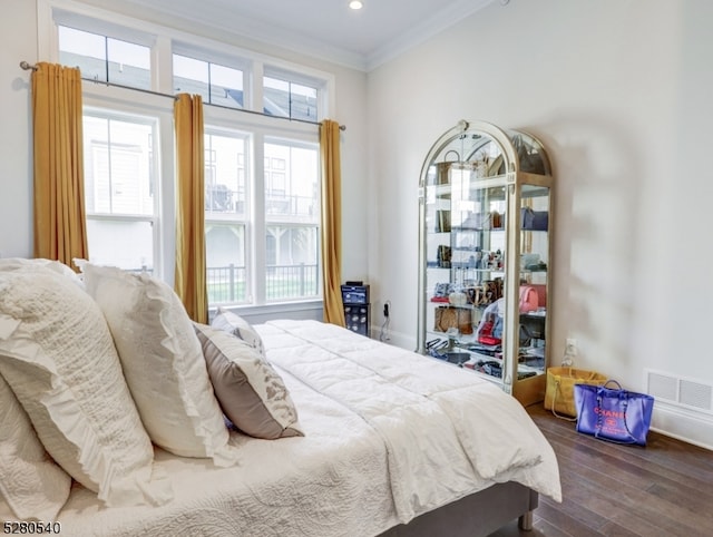 bedroom featuring ornamental molding and dark wood-type flooring