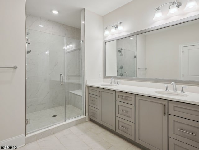 bathroom featuring double sink vanity, a shower with door, and tile floors