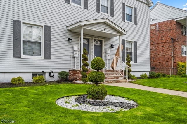 property entrance with a lawn