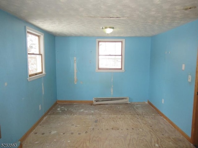 spare room featuring a baseboard radiator and baseboards