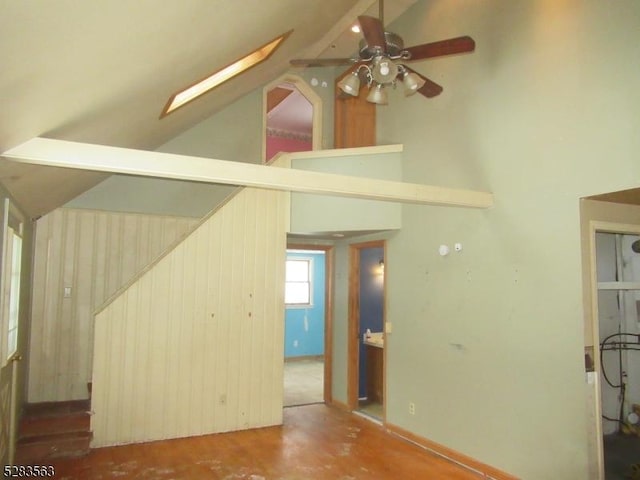 unfurnished living room featuring high vaulted ceiling