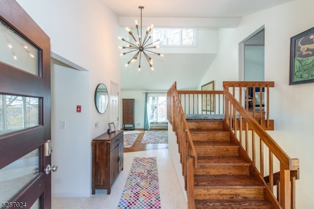 stairway featuring a chandelier