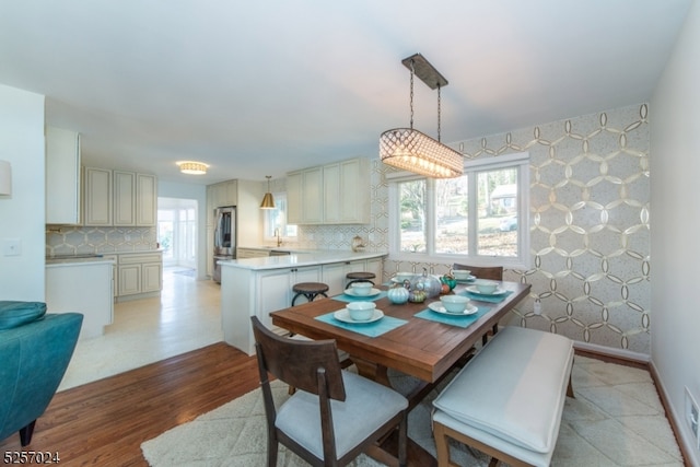 dining room with sink and light hardwood / wood-style floors