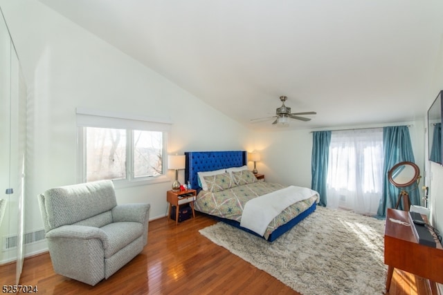 bedroom featuring ceiling fan, wood-type flooring, and vaulted ceiling