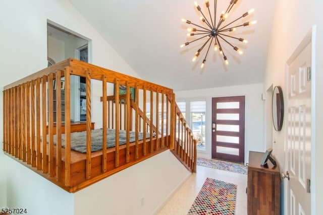 entrance foyer with vaulted ceiling and a chandelier